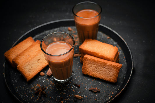 A cup of chai with biscuits
