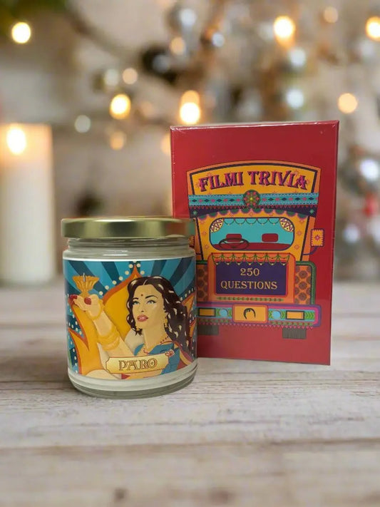 Diwali gift set bundle featuring Filmi Trivia, a Bollywood themed Trivia card game, and the Paro Candle, a chai scented candle with artwork of Paro played by Aishwarya Rai in the Bollywood movie Devdas holding a diya.