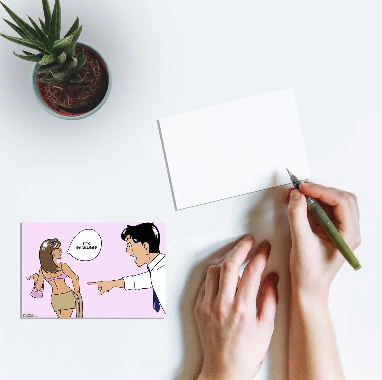 A person writing on a postcard with line art of Shah Rukh Khan and Kareena Kapoor with the dialogue "It's Backless" from the Bollywood film Kabhi Khushi Kabhie Gham.